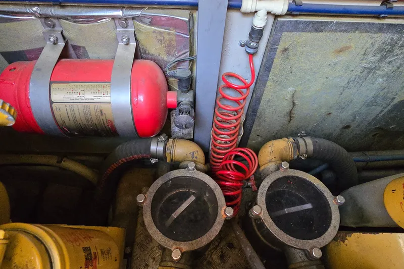 Slide: The Image of Engine room of 1994 Sunseeker Mustique 42 with fire extinguisher and hoses. - 36