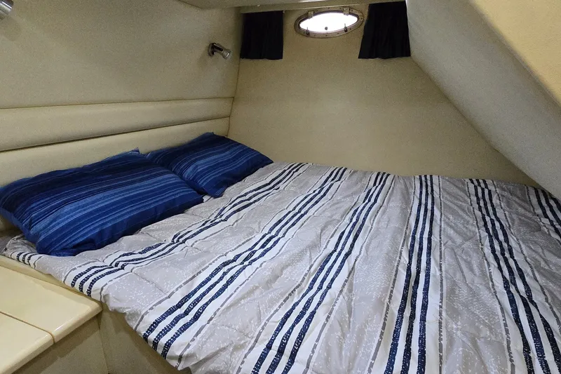 Slide: The Image of Cozy cabin bedroom in 1994 Sunseeker Mustique 42 yacht with striped bedding. - 24