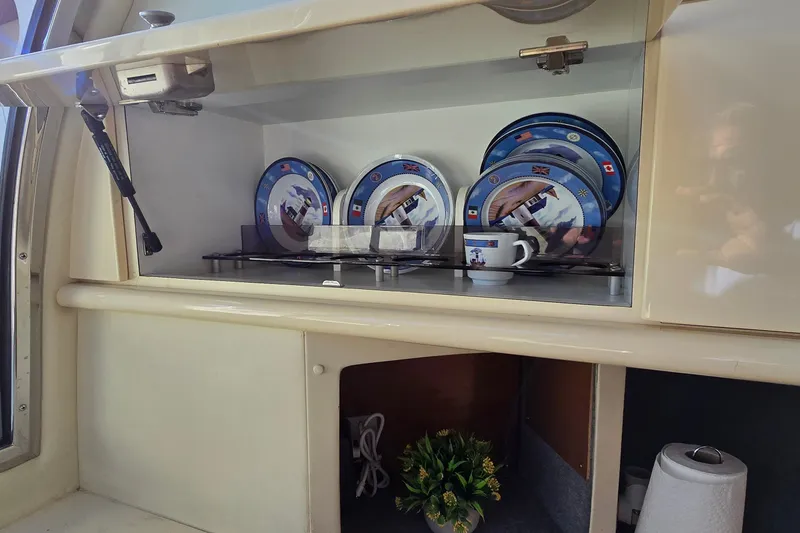 Slide: The Image of Cabinet with decorative plates and mug inside a 1994 Sunseeker Mustique 42 yacht. - 29