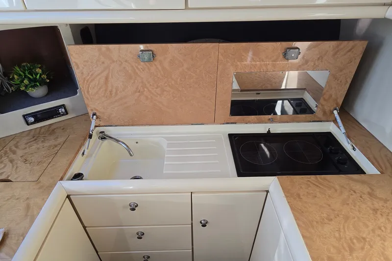 Slide: The Image of Sunseeker Mustique 42 yacht kitchen with sink, stove, and wooden cabinetry, 1994 model. - 15