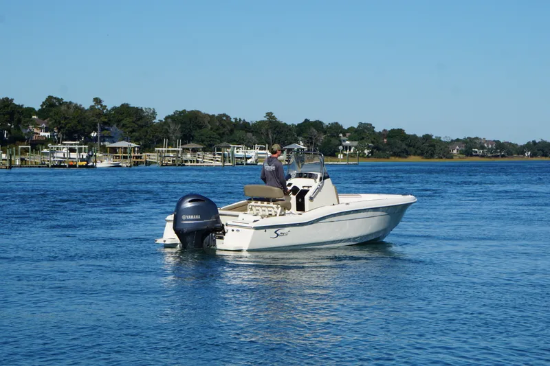 Slide: The Image of 2016 Scout 210 XSF boat on calm water with Yamaha outboard motor. - 3