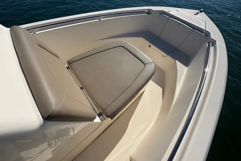 Slide: The Image of 2016 Scout 210 XSF boat interior with cushioned seating and stainless steel railings. - 7