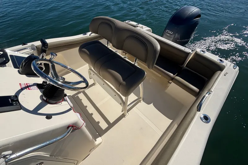 Slide: The Image of 2016 Scout 210 XSF boat interior with steering wheel and seating on water. - 9