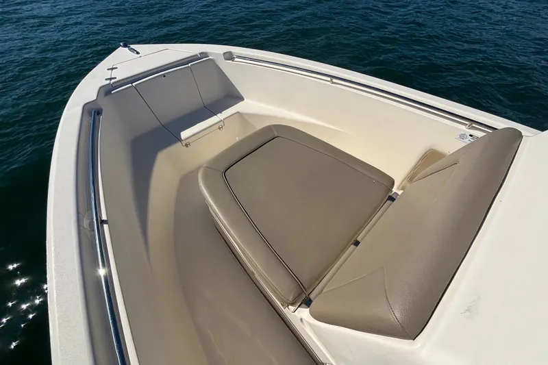 Slide: The Image of 2016 Scout 210 XSF boat with cushioned seating on calm water. - 8
