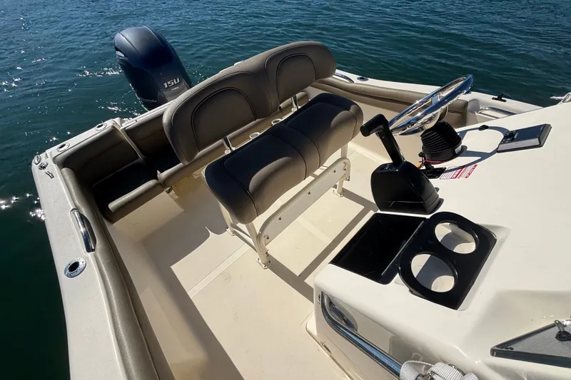 Slide: The Image of 2016 Scout 210 XSF boat interior with steering wheel and seating. - 10