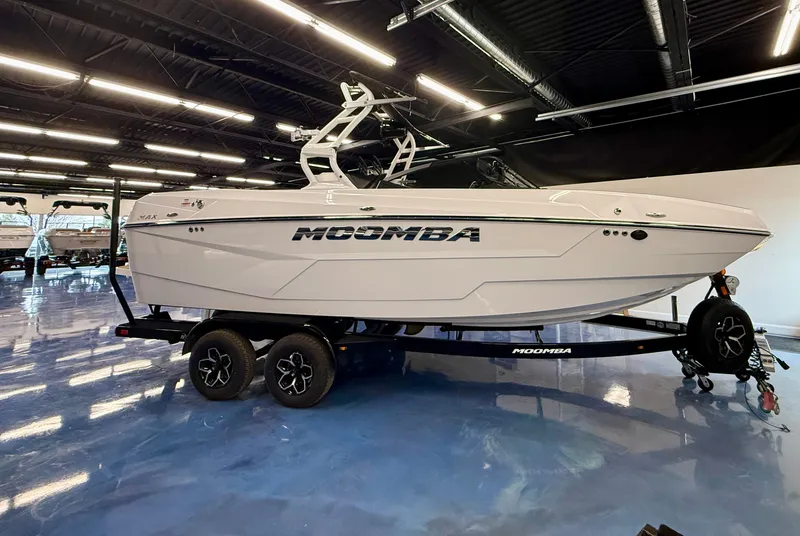 Slide: The Image of A 2026 Moomba Max boat on a trailer in a showroom. - 23