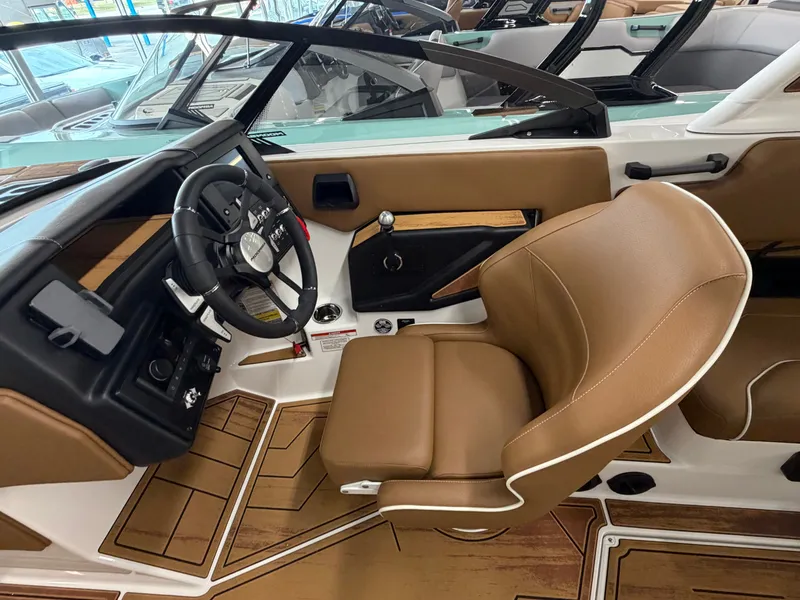 Slide: The Image of The image shows the cockpit of a 2026 Moomba Max with brown leather seats and a modern dashboard. - 14