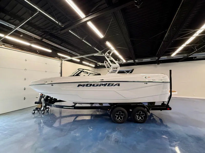 Slide: The Image of A 2026 Moomba Max boat in a showroom, placed on a trailer. - 22