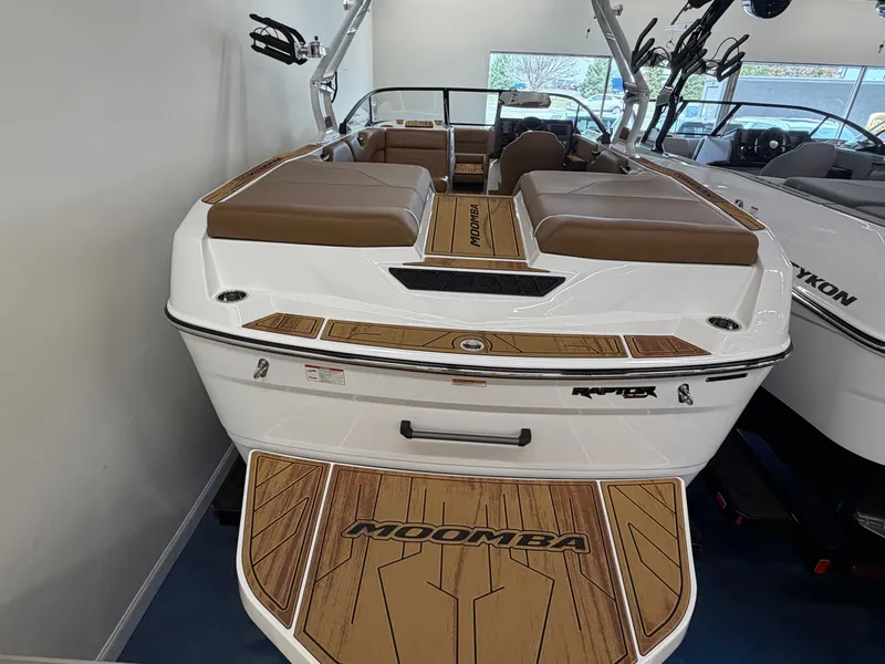 The Image of The image shows a 2026 Moomba Max boat with brown seating and a sleek design. - 1
