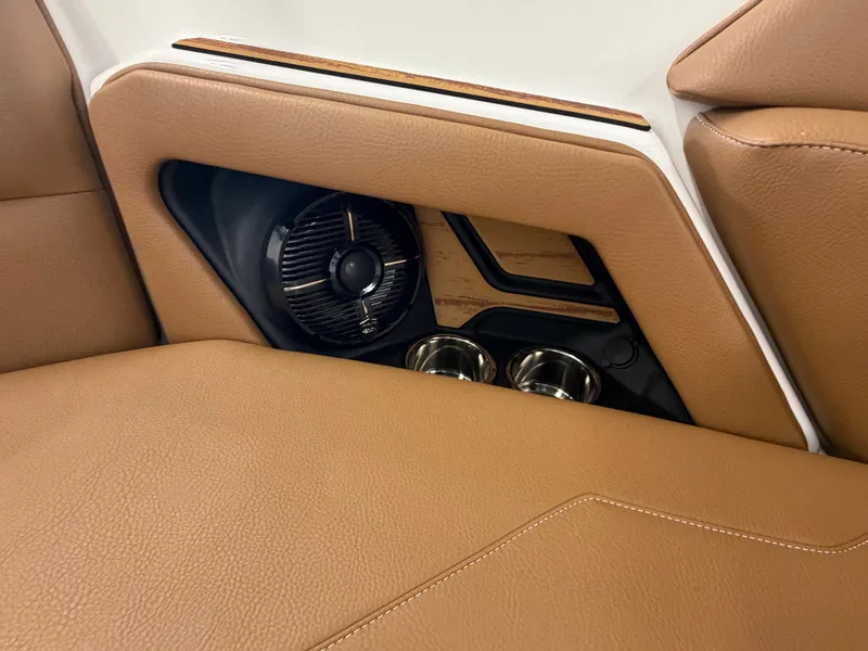 Slide: The Image of Close-up of a brown leather seat with built-in speaker and cup holders. - 17
