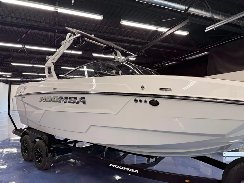 Slide: The Image of A white 2026 Moomba Max boat on a trailer in a showroom setting. - 21