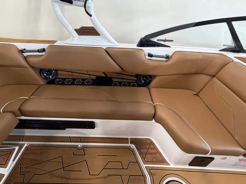 Slide: The Image of The image shows the interior of a 2026 Moomba Max boat with brown leather seating. - 15