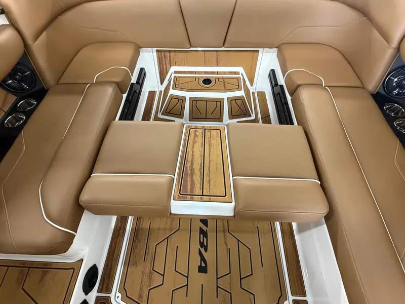 Slide: The Image of Interior of a 2026 Moomba Max with brown upholstery and stylish wood flooring. - 18