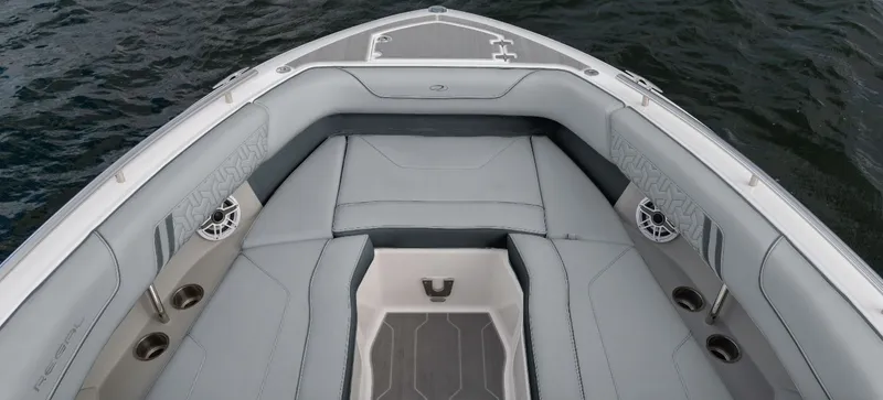 Slide: The Image of The image shows the bow of a Regal LS9 boat with gray upholstery and speakers. - 2