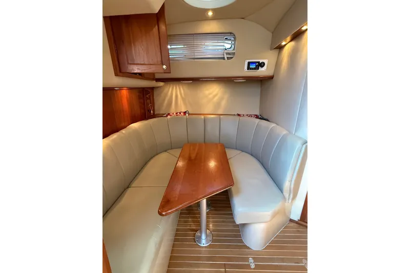 Slide: The Image of Interior of 2006 Rampage 38 Express yacht with cozy seating and wooden table. - 14