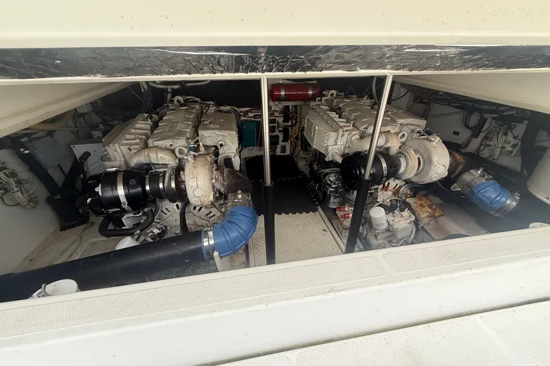Slide: The Image of Engine compartment of a 2006 Rampage 38 Express boat, showcasing dual engines. - 18