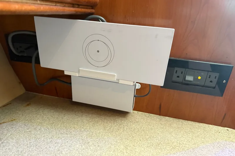 Slide: The Image of Power outlet and device on a 2006 Rampage 38 Express boat interior. - 17