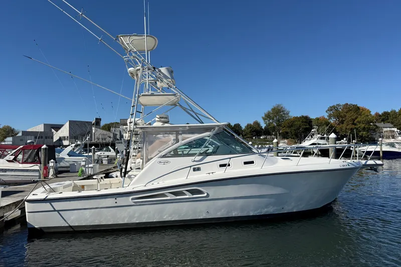 The Image of 2006 Rampage 38 Express boat docked at marina under clear blue sky. - 0