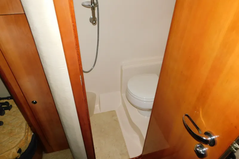 Slide: The Image of Bathroom interior of 2004 Regal Commodore 3860 yacht with wooden door and shower. - 92