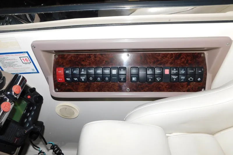 Slide: The Image of Control panel of a 2004 Regal Commodore 3860 boat with various switches and buttons. - 42