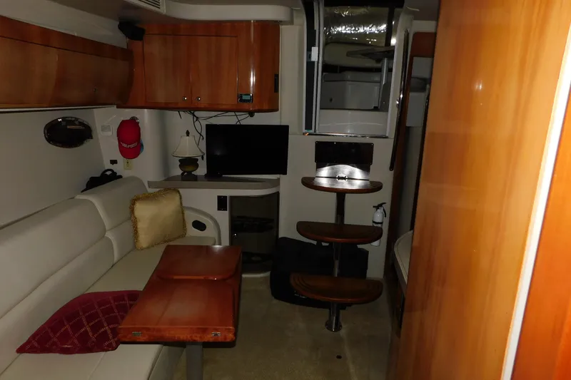 Slide: The Image of Interior of 2004 Regal Commodore 3860 yacht with wood finishes and cozy seating area. - 74