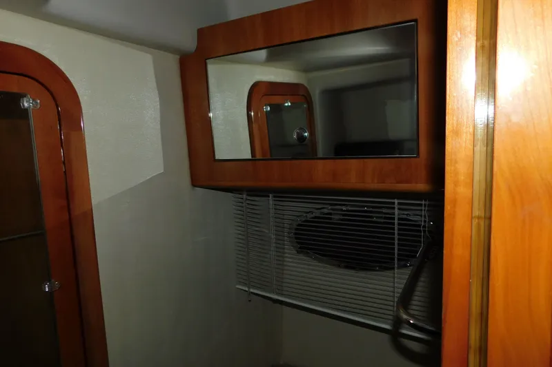 Slide: The Image of 2004 Regal Commodore 3860 yacht interior with wood accents and mirror. - 88