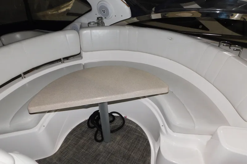 Slide: The Image of 2004 Regal Commodore 3860 boat interior with curved seating and table. - 46