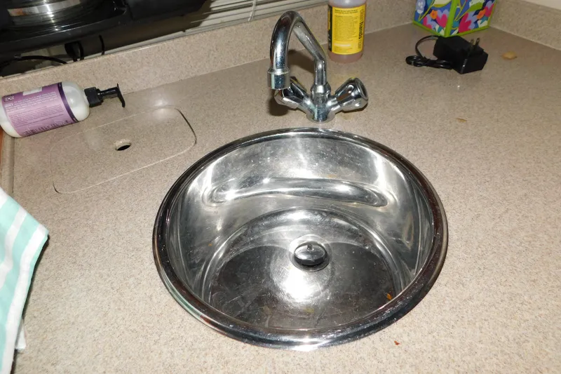 Slide: The Image of Stainless steel sink on Regal Commodore 3860 yacht, 2004 model, with countertop accessories. - 79