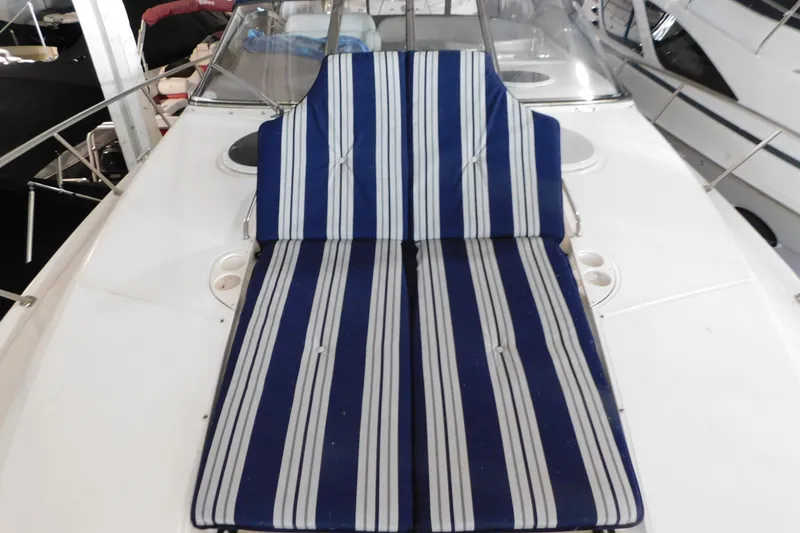 Slide: The Image of 2004 Regal Commodore 3860 boat with blue striped deck cushions. - 101