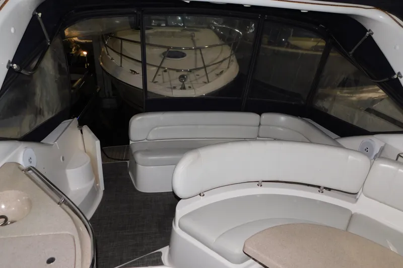 Slide: The Image of Interior of 2004 Regal Commodore 3860 yacht with white seating and table. - 48