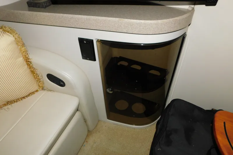 Slide: The Image of 2004 Regal Commodore 3860 interior with beige seating and a small cabinet. - 56