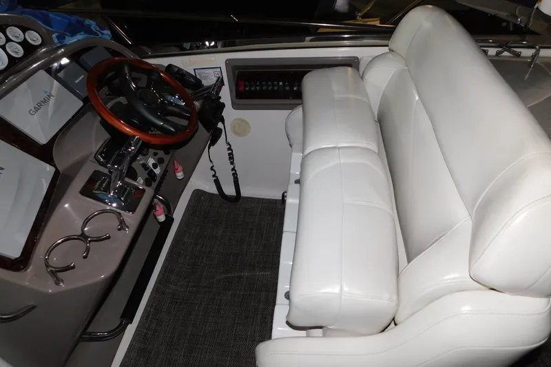 Slide: The Image of 2004 Regal Commodore 3860 helm with white leather seating and wooden steering wheel. - 37