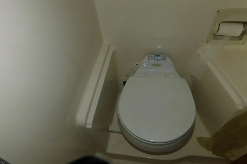 Slide: The Image of 2004 Regal Commodore 3860 boat bathroom with toilet and toilet paper holder. - 95