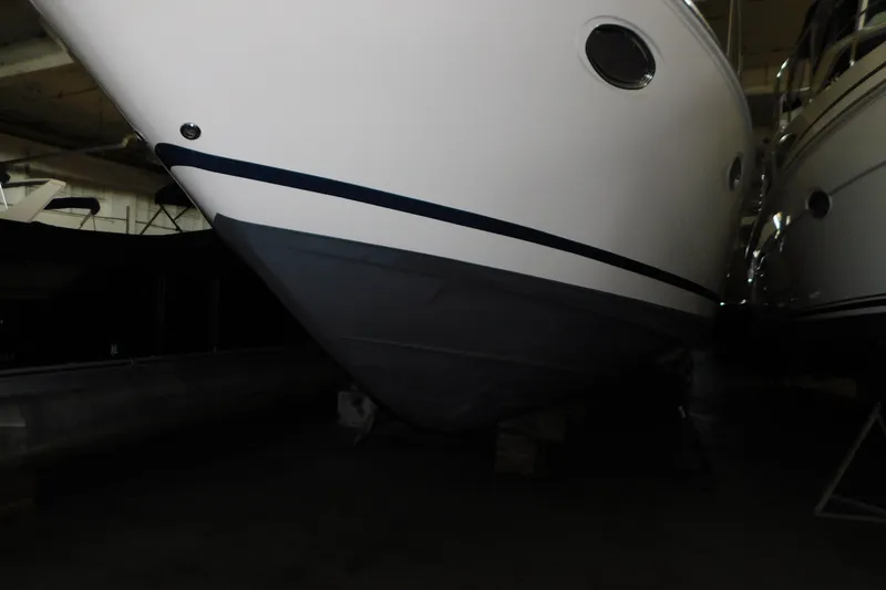 Slide: The Image of 2004 Regal Commodore 3860 yacht in storage, showcasing sleek hull design. - 9