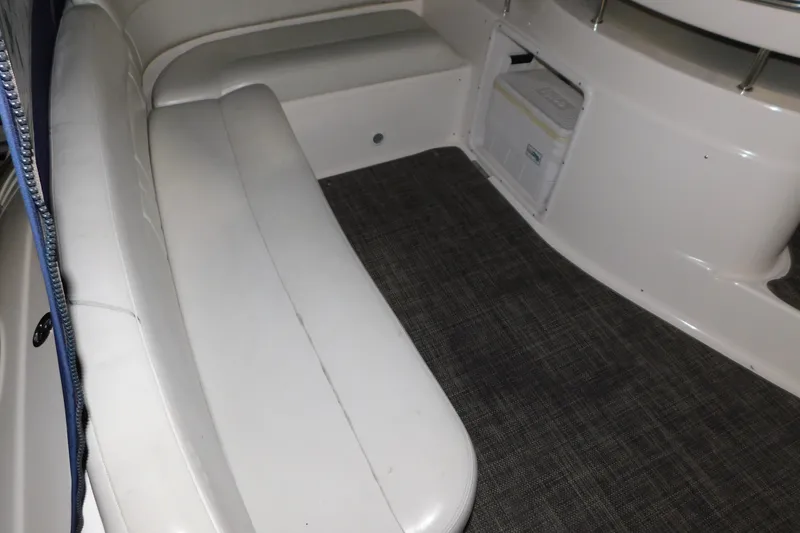 Slide: The Image of 2004 Regal Commodore 3860 boat interior with white seating and carpeted floor. - 24
