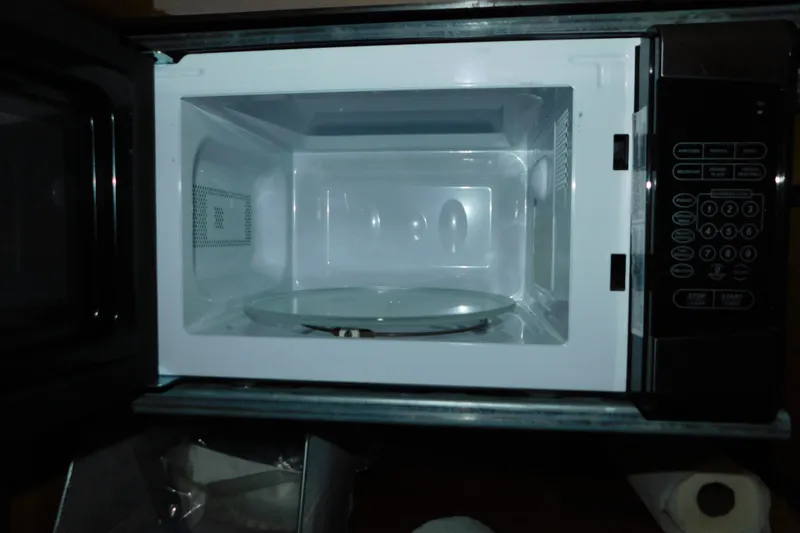 Slide: The Image of Open microwave oven with digital control panel and glass turntable. - 85