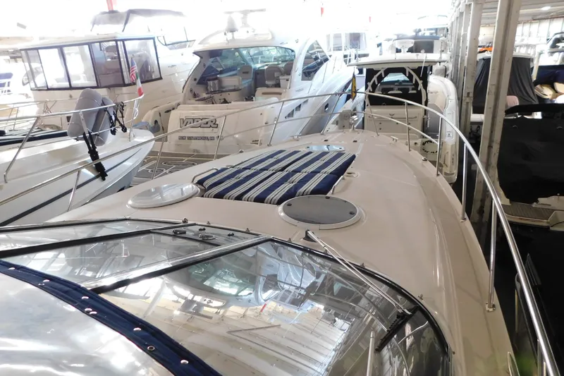 Slide: The Image of 2004 Regal Commodore 3860 yacht docked among other boats in a marina. - 97