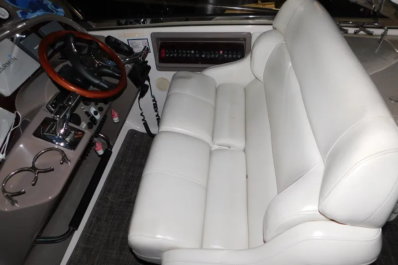 Slide: The Image of 2004 Regal Commodore 3860 helm with white leather seating and wooden steering wheel. - 38