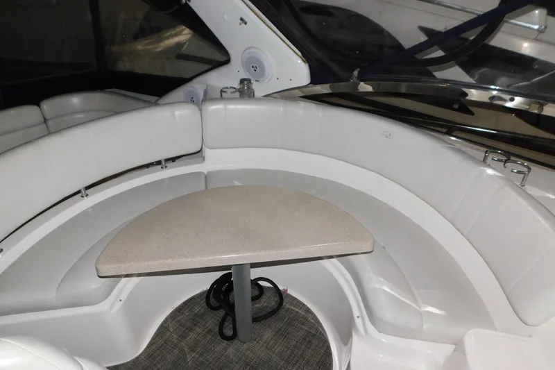 Slide: The Image of 2004 Regal Commodore 3860 boat interior with curved seating and small table. - 47