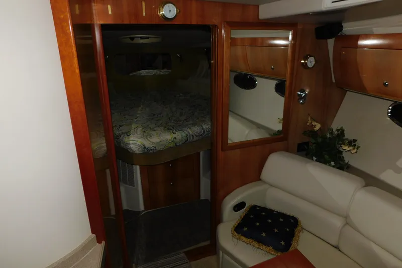Slide: The Image of Interior of 2004 Regal Commodore 3860 yacht with cozy seating and elegant wood finishes. - 54