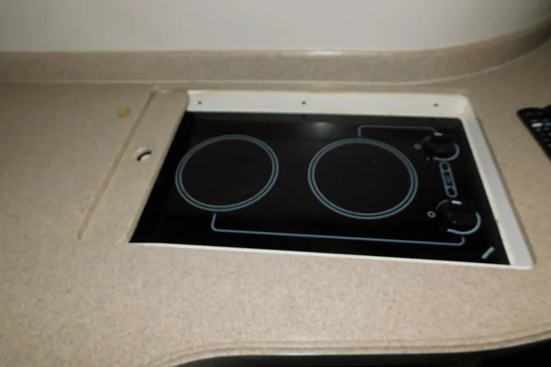 Slide: The Image of 2004 Regal Commodore 3860 kitchen stove with dual burners and control knobs. - 80