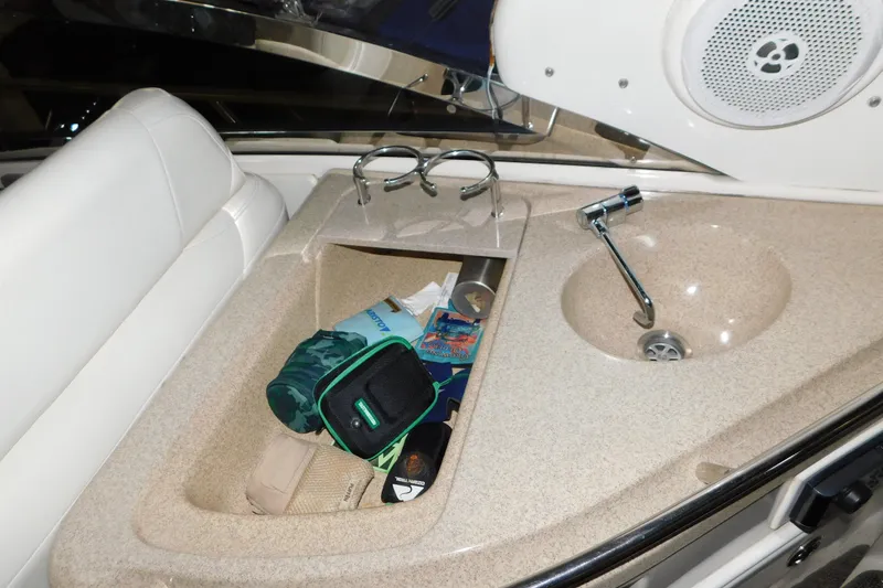 Slide: The Image of 2004 Regal Commodore 3860 boat interior with sink, storage, and speaker. - 36