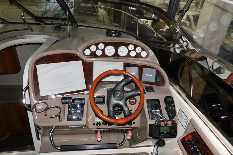 Slide: The Image of 2004 Regal Commodore 3860 helm with gauges, steering wheel, and navigation equipment. - 41