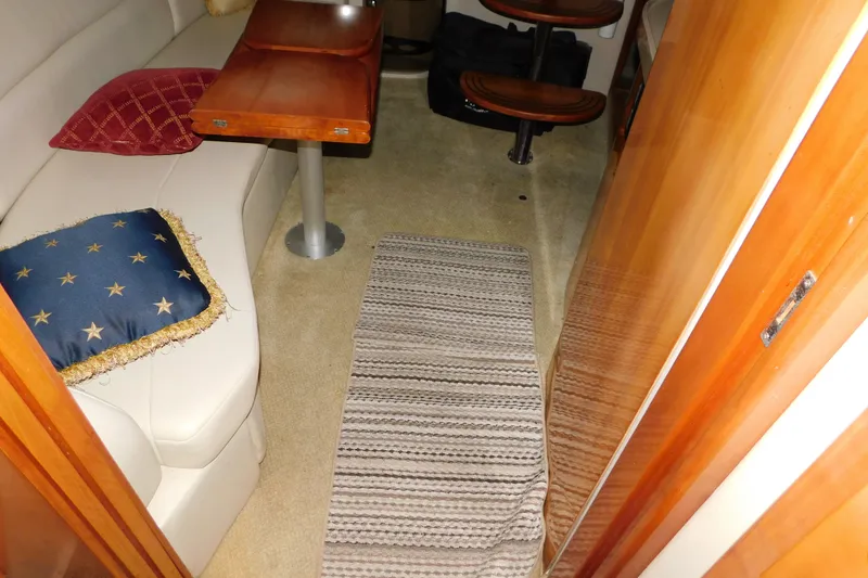 Slide: The Image of Interior of 2004 Regal Commodore 3860 yacht with seating and wooden table. - 73