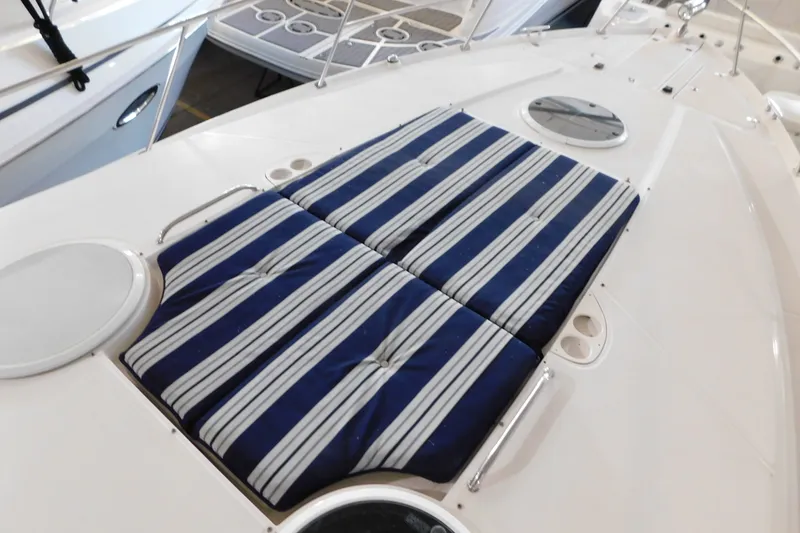 Slide: The Image of 2004 Regal Commodore 3860 boat with striped deck cushions. - 98
