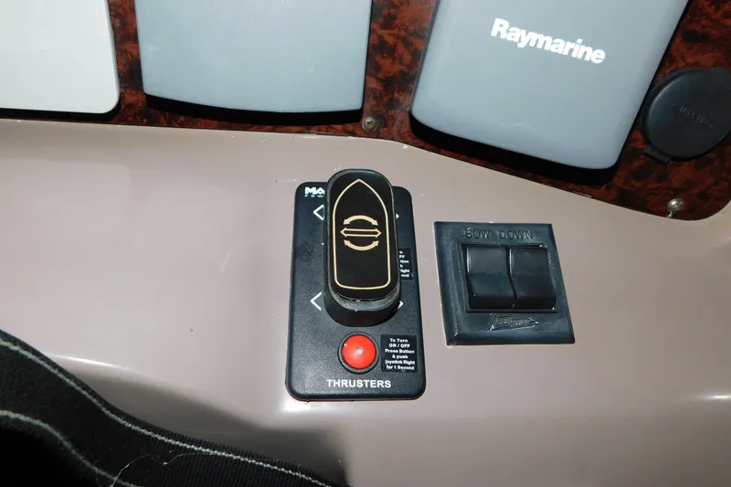 Slide: The Image of Control panel of a 2004 Regal Commodore 3860 boat with thruster and Raymarine equipment. - 44