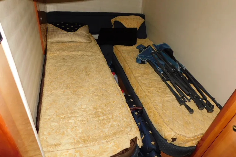 Slide: The Image of 2004 Regal Commodore 3860 cabin with twin beds and folded chairs. - 90