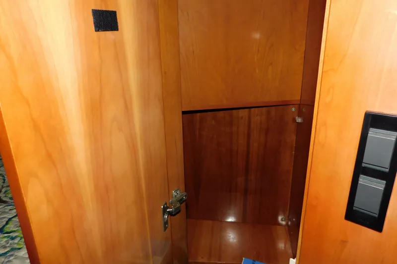 Slide: The Image of Wooden interior of a 2004 Regal Commodore 3860 boat, featuring a storage compartment. - 62