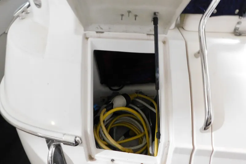 Slide: The Image of Open storage compartment on 2004 Regal Commodore 3860 boat with coiled yellow cables. - 16
