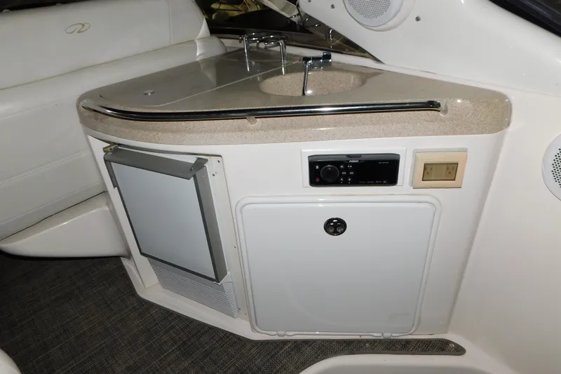 Slide: The Image of 2004 Regal Commodore 3860 yacht interior with sink, mini-fridge, and control panel. - 30